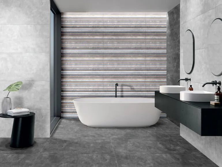 Sleek grey bathroom design with sandy smoke tiles, white bathtub, sink and modern mirror